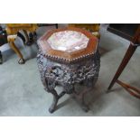 A Chinese padouk wood and marble topped jardiniere stand