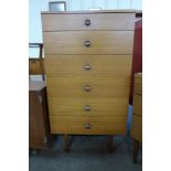 A teak chest of drawers