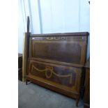 An early 20th Century French Empire style inlaid mahogany and amboyna kingsize bed