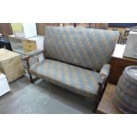 A 1930's oak and upholstered settle