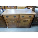 An Arts and Crafts carved walnut sideboard