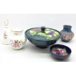 Three items of Moorcroft; a vase, small chip to the rim, lidded bowl, base cracked, a small bowl and