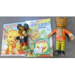 A Rupert the Bear bendy toy, a Mickey Mouse bendy toy and two Rupert annuals