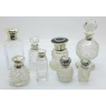 A collection of eight silver topped and mounted cut glass scent and dressing table bottles,