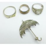 Three silver rings and a hallmarked silver and marcasite umbrella brooch