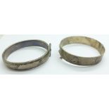 A silver wax filled bangle and one other silver bangle, 68g