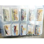 Cigarette cards; twelve complete sets in album including Wills Celebrated Ships, Playes Ceremonial