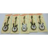 A set of five The Beatles guitar brooches on card