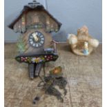 A cuckoo clock with weights and a Sylvac posy vase