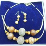 A necklace, earrings and bracelet jewellery set