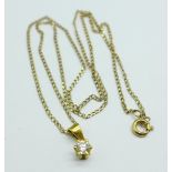 A diamond pendant set in yellow metal, tests as 18ct gold, on a 9ct gold chain, approximately 0.