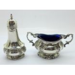 A silver pepperette and two handled salt with liner by Walker & Hall, Sheffield, hallmarks for