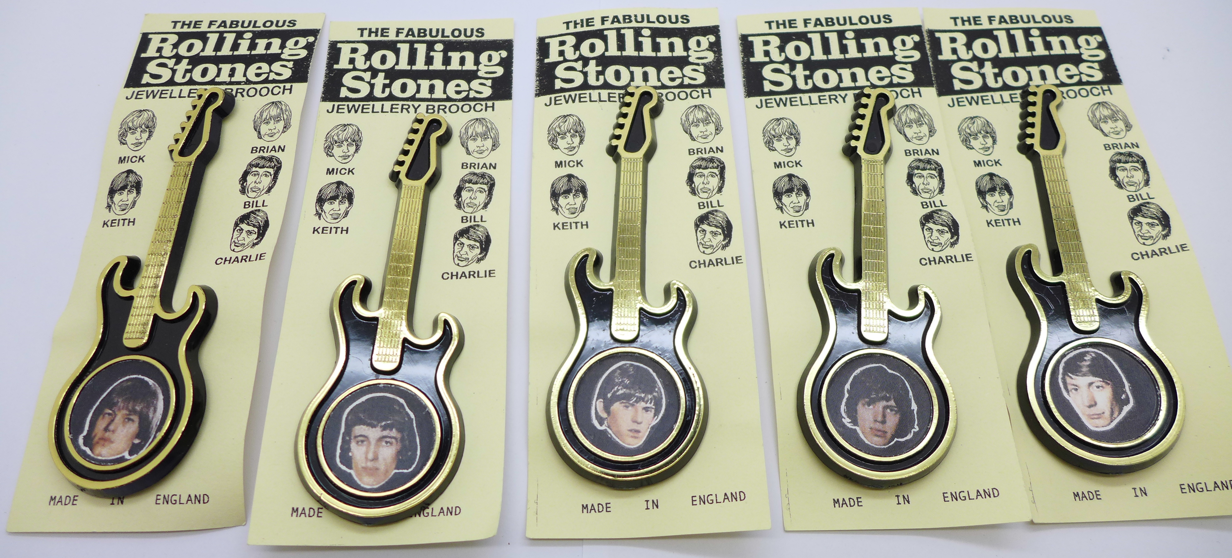 A set of five Rolling Stones guitar brooches on card