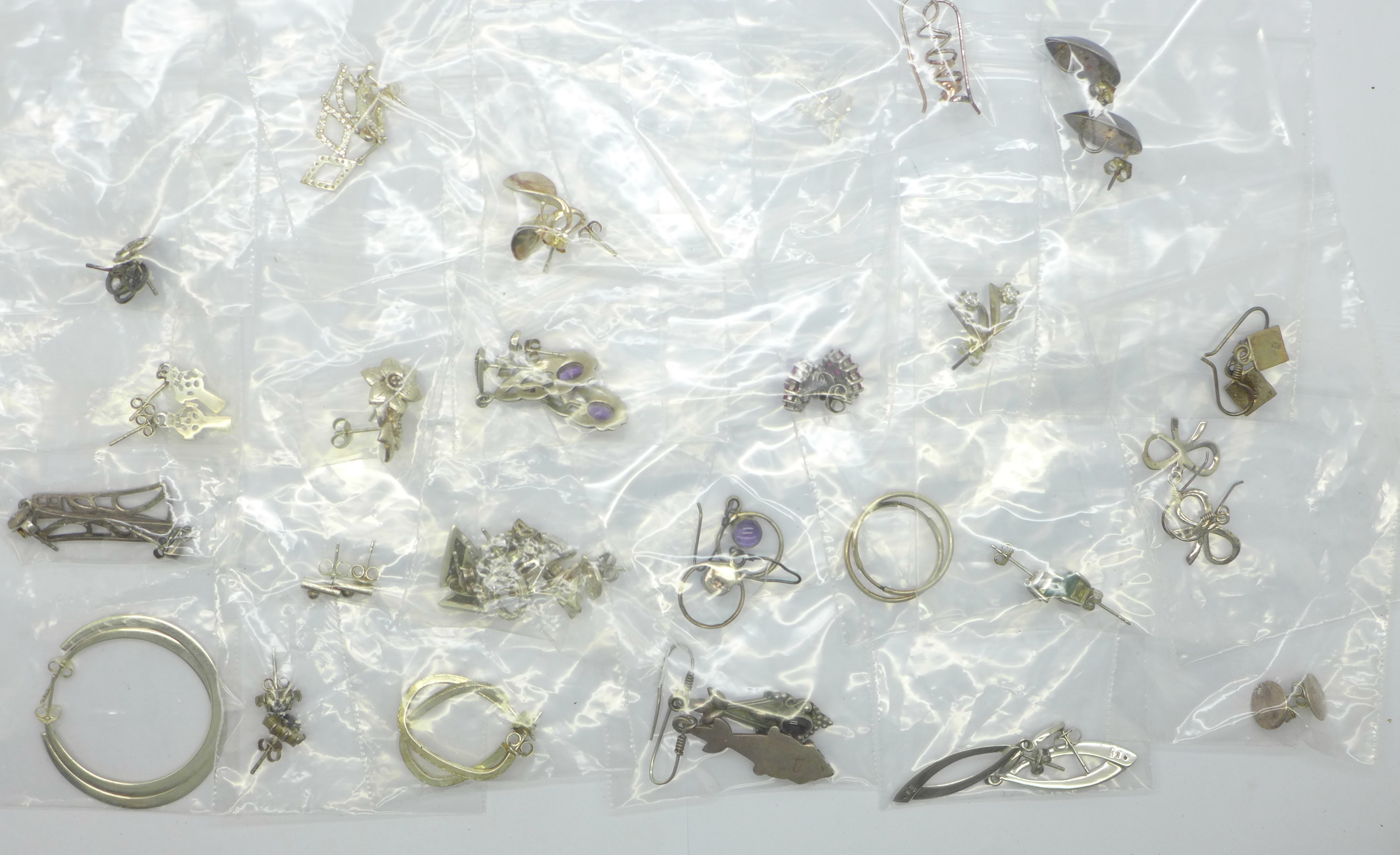 Twenty-five pairs of silver earrings