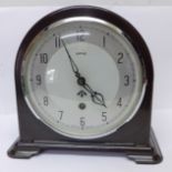 A Smiths Bakelite mantel clock with broad arrow on the dial