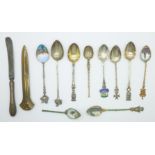 A collection of spoons including enamel souvenir spoons, a knife and a letter opener, (six spoons
