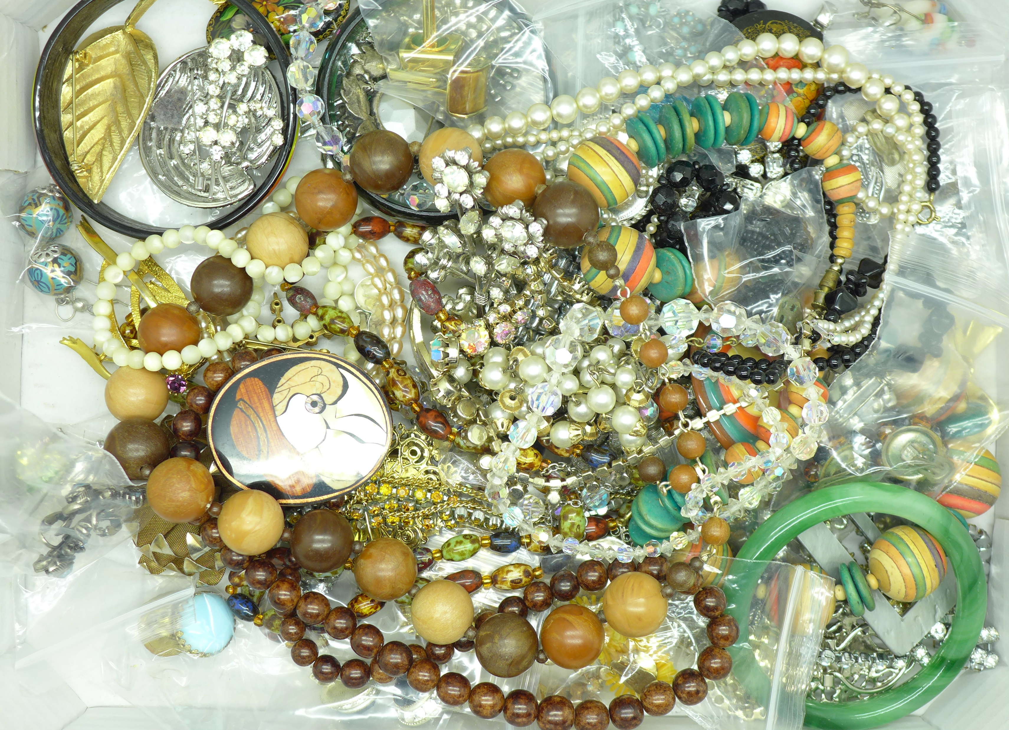 A collection of vintage jewellery and brooches including beaded necklaces and bangles