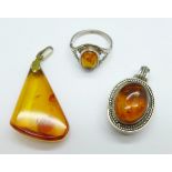 Two amber set pendants and a ring, ring size Q