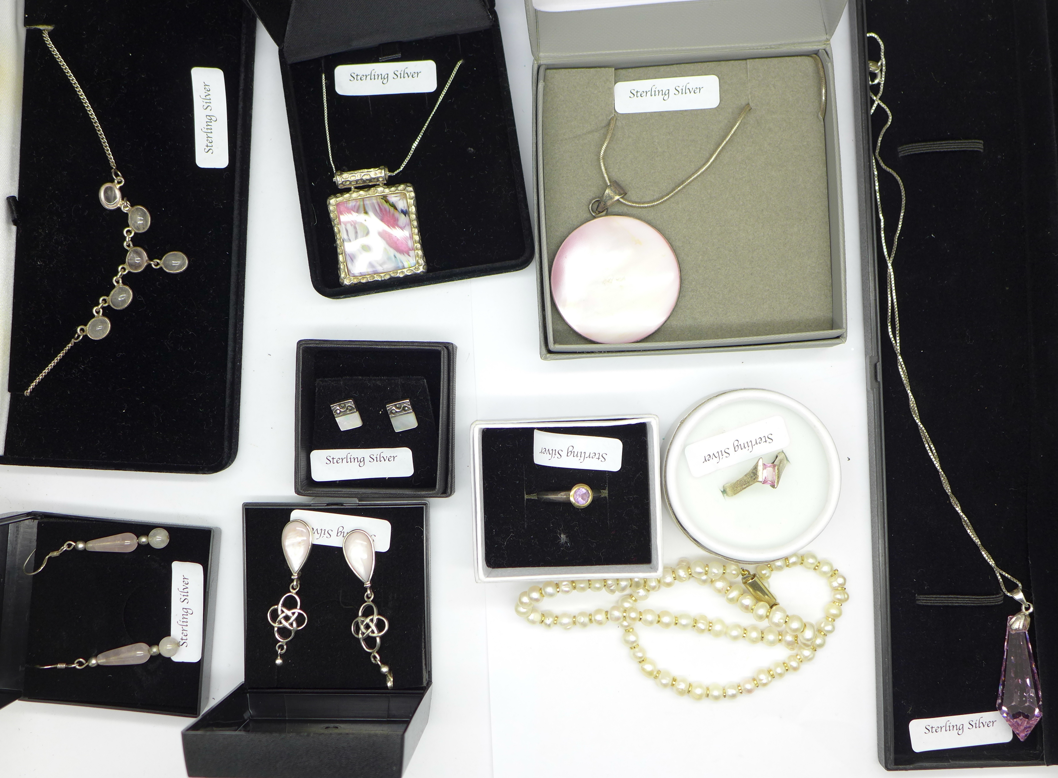 A collection of silver jewellery including mother of pearl, rose quartz and other pink stones