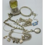 A collection of silver jewellery including a bangle, charm bracelet, locket on chain and marcasite