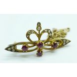 An Arts and Crafts old cut diamond and ruby set brooch, tests as 14/15ct gold, 3.3g, 31mm