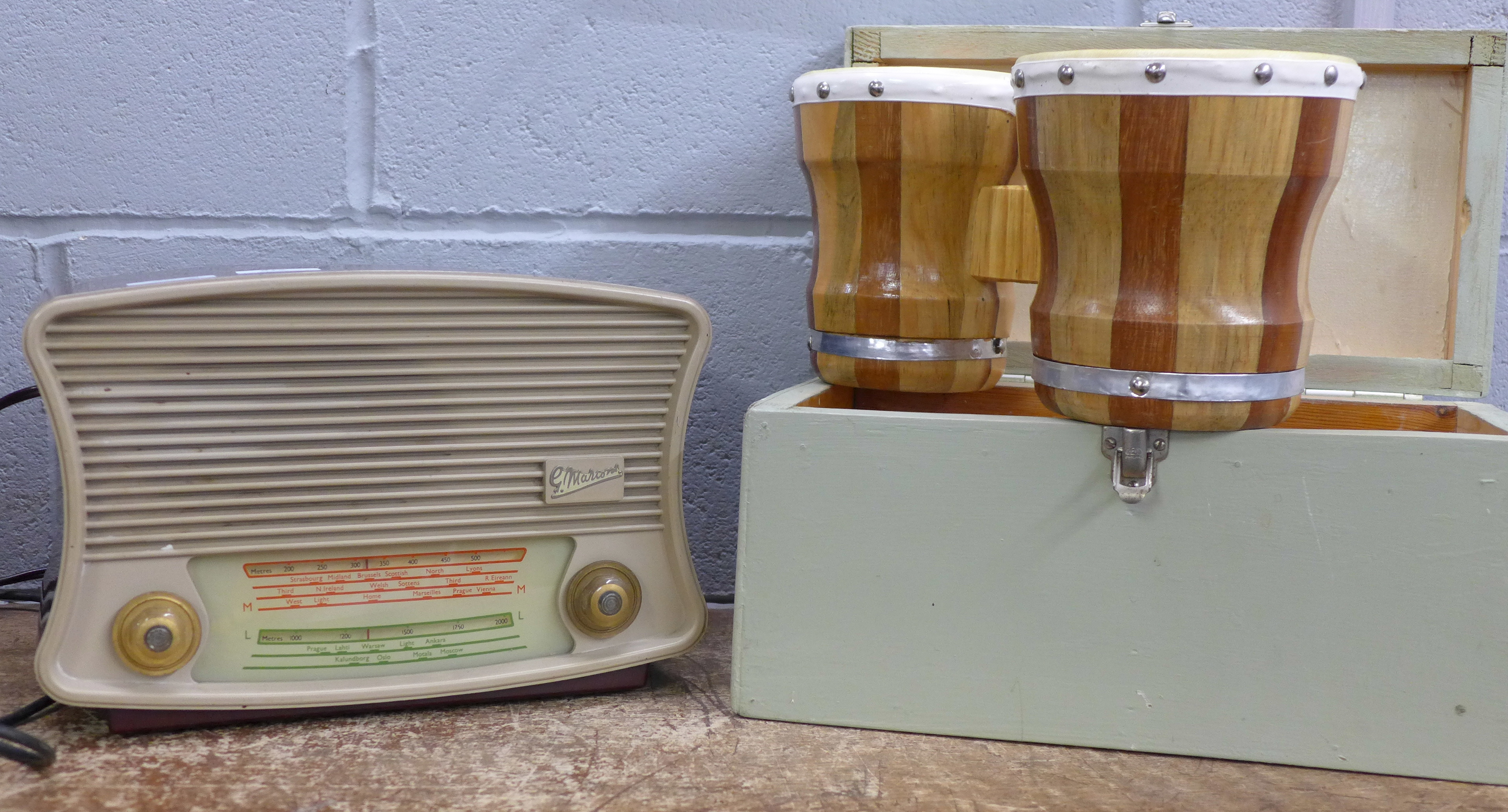 A Marconi radio and a set of bongo drums, cased