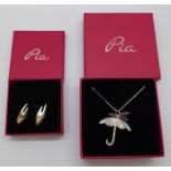 A silver designer pendant and chain and a pair of earrings by Pia, boxed