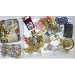 A collection of badges, costume rings and costume jewellery