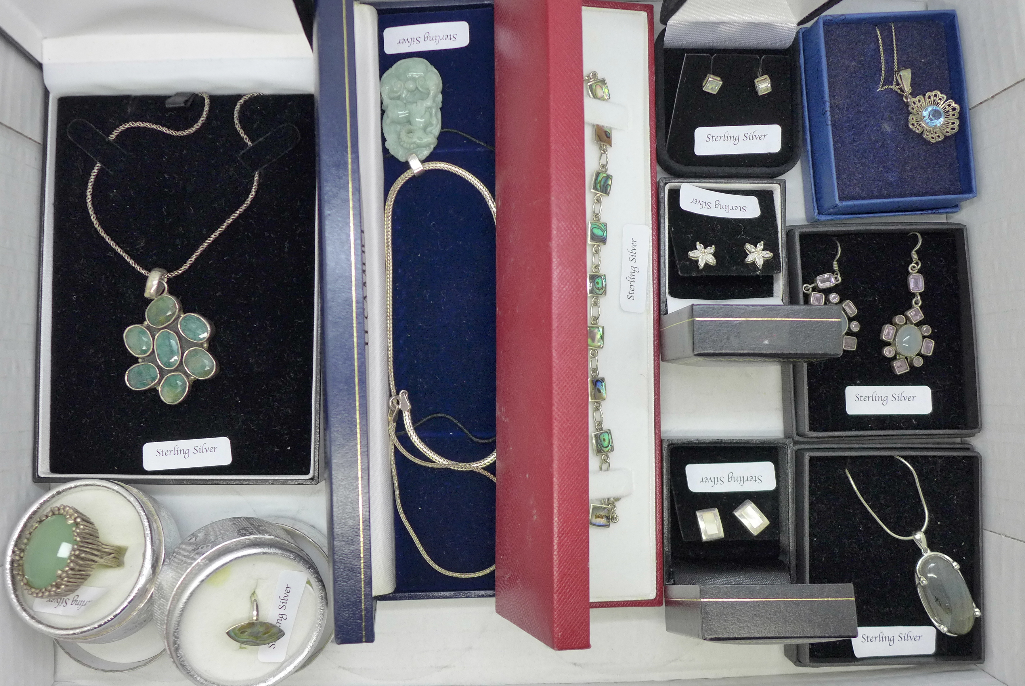 A collection of silver jewellery including abalone and green stones