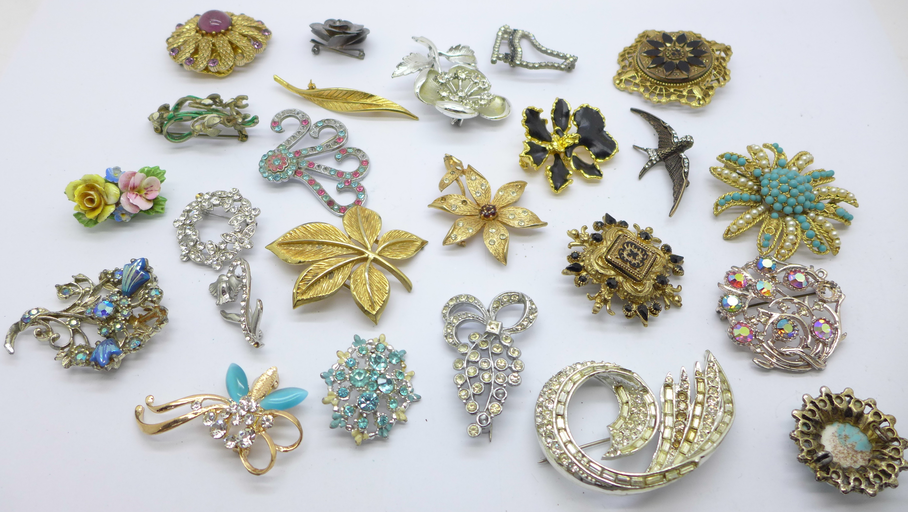 Twenty-five costume brooches, some lacking paste stones