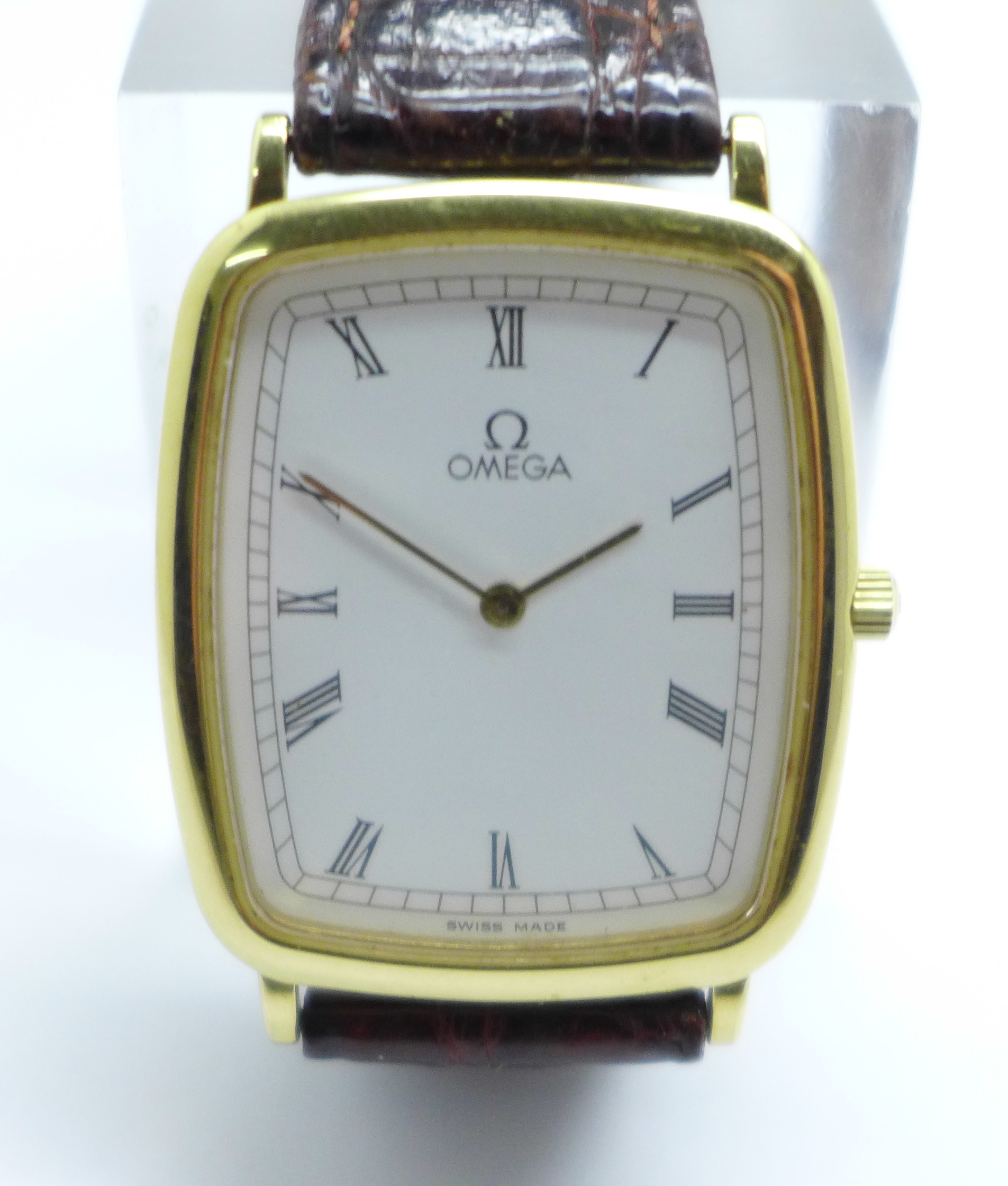 An Omega DeVille wristwatch with Omega strap and buckle, 26mm case