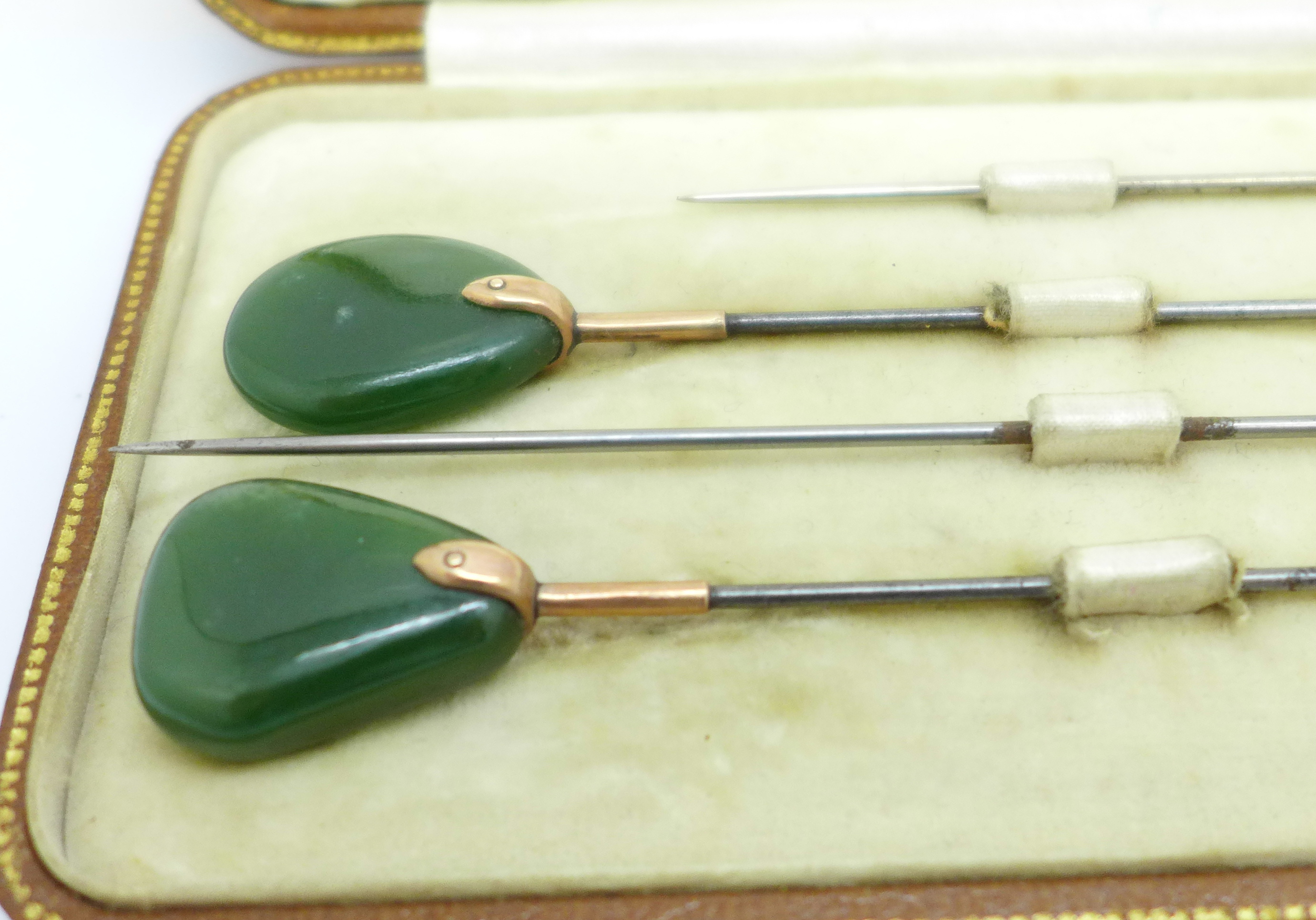 A cased set of four yellow metal mounted and jade hat pins - Image 2 of 3