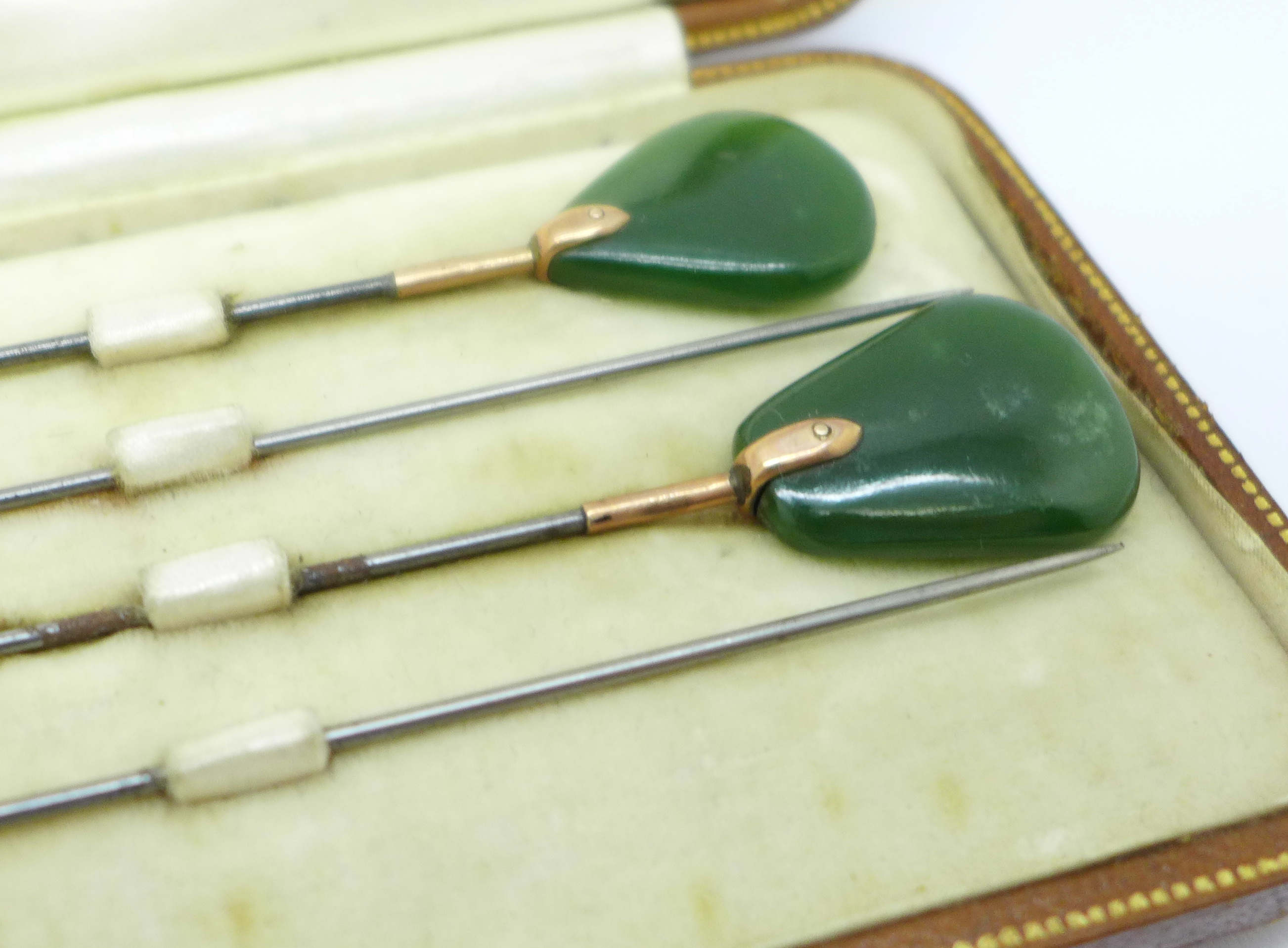 A cased set of four yellow metal mounted and jade hat pins - Image 3 of 3