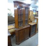 A mahogany freestanding corner cabinet