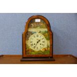 A faux walnut mantel clock, with wildlife scene dial
