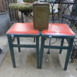 A pair of painted stools and a fuel can
