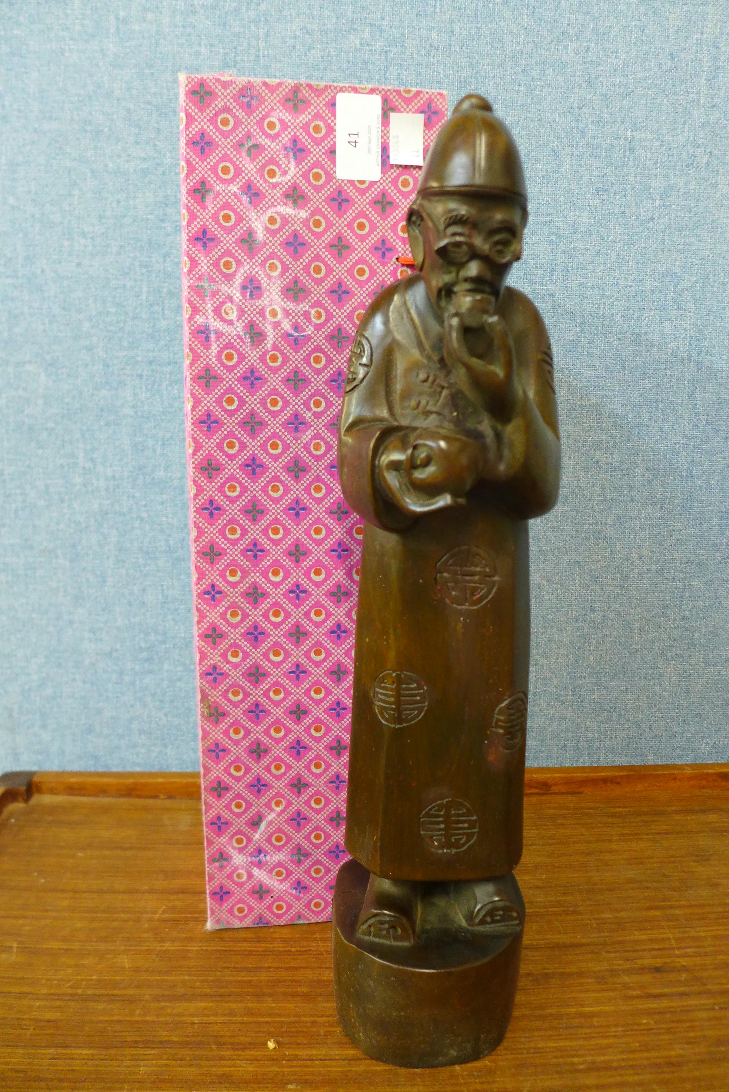An oriental carved wood figure of a sage, 41cms h