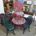 A cast alloy garden table and four chairs