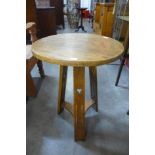 An Arts and Crafts oak circular occasional table