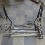 A wrought iron garden bench frame