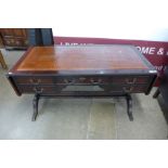 A Regency style mahogany and maroon leather topped library desk
