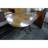 A Regency style mahogany pedestal dining table