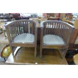 A pair of Arts and Crafts style beech tub chairs