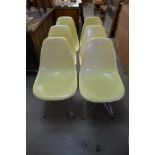 A set of six Eames style chrome and plastic chairs