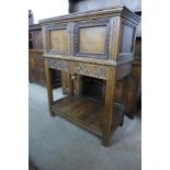 A 17th Century style carved oak credence cupboard on stand, signed J. Wallace, 112cms h, 88cms w,