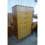 A teak chest of drawers