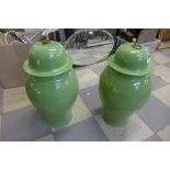 A pair of large oriental olive green porcelain ginger jars with covers