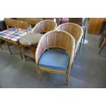 A set of three bamboo armchairs and a table