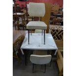 A Formica kitchen table and three chairs