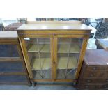 A carved oak display cabinet